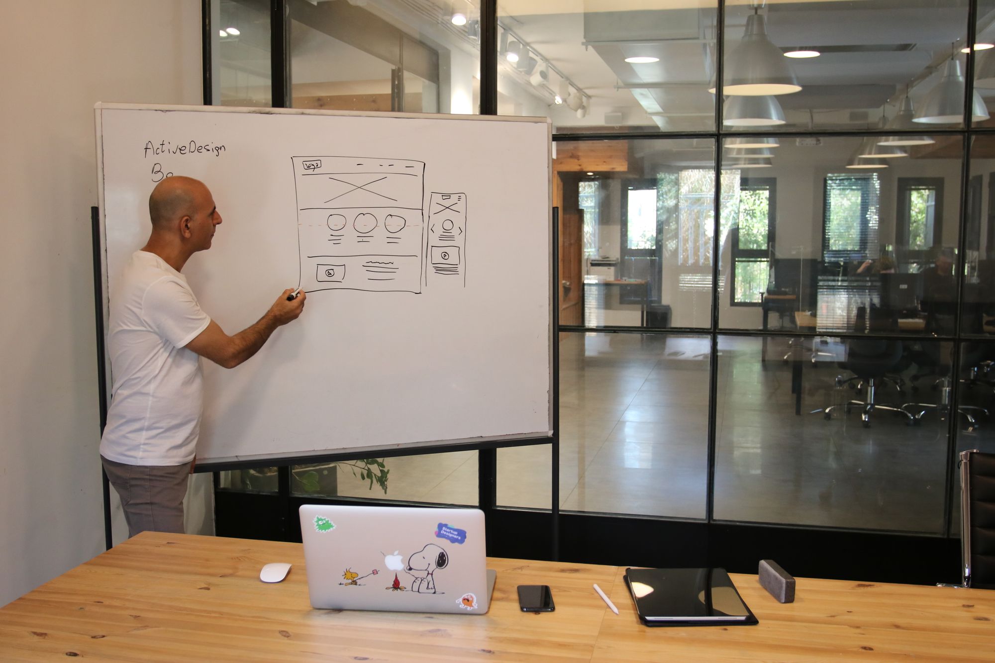 A system sketch being developed on a whiteboard in a working studio